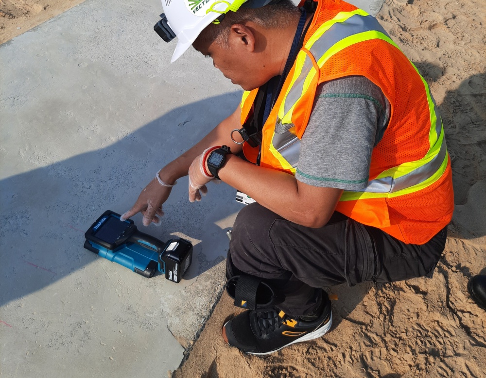 An engineer performing GPR reading on a concrete slab
